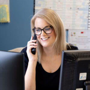 Claire in Epic Solutions reception answering the phone